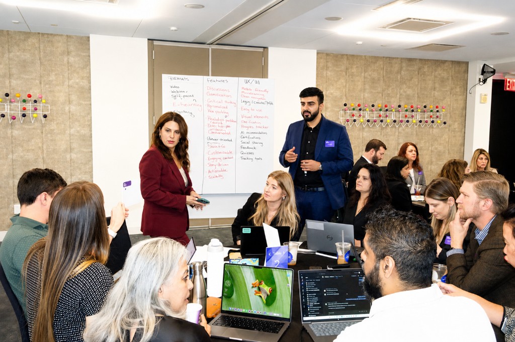 Senior leaders co-designing product features on whiteboards at the Makers Summit